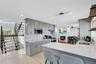 Kitchen with gray cabinets, light stone countertops, light wood-style flooring, and recessed lighting