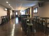 Dining space featuring a drop ceiling, a wall mounted air conditioner, and dark hardwood / wood-style flooring