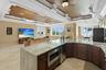 Quartzite full bar with microwave, a Scotsman specialty icemaker and large full screen TV with breathtaking sunset views and a balcony overlooking the
