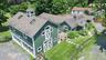 Featuring a multi-gabled roofline and multiple skylights.