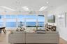 Living room featuring light wood-style flooring, healthy amount of natural light, recessed lighting, ceiling fan, and a skylight