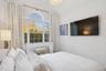 Bedroom with lofted ceiling