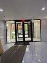 Building lobby with floor to ceiling windows and recessed lighting