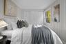 Bright third bedroom with fresh finishes and generous closet space, offering a comfortable setting for rest or relaxation.