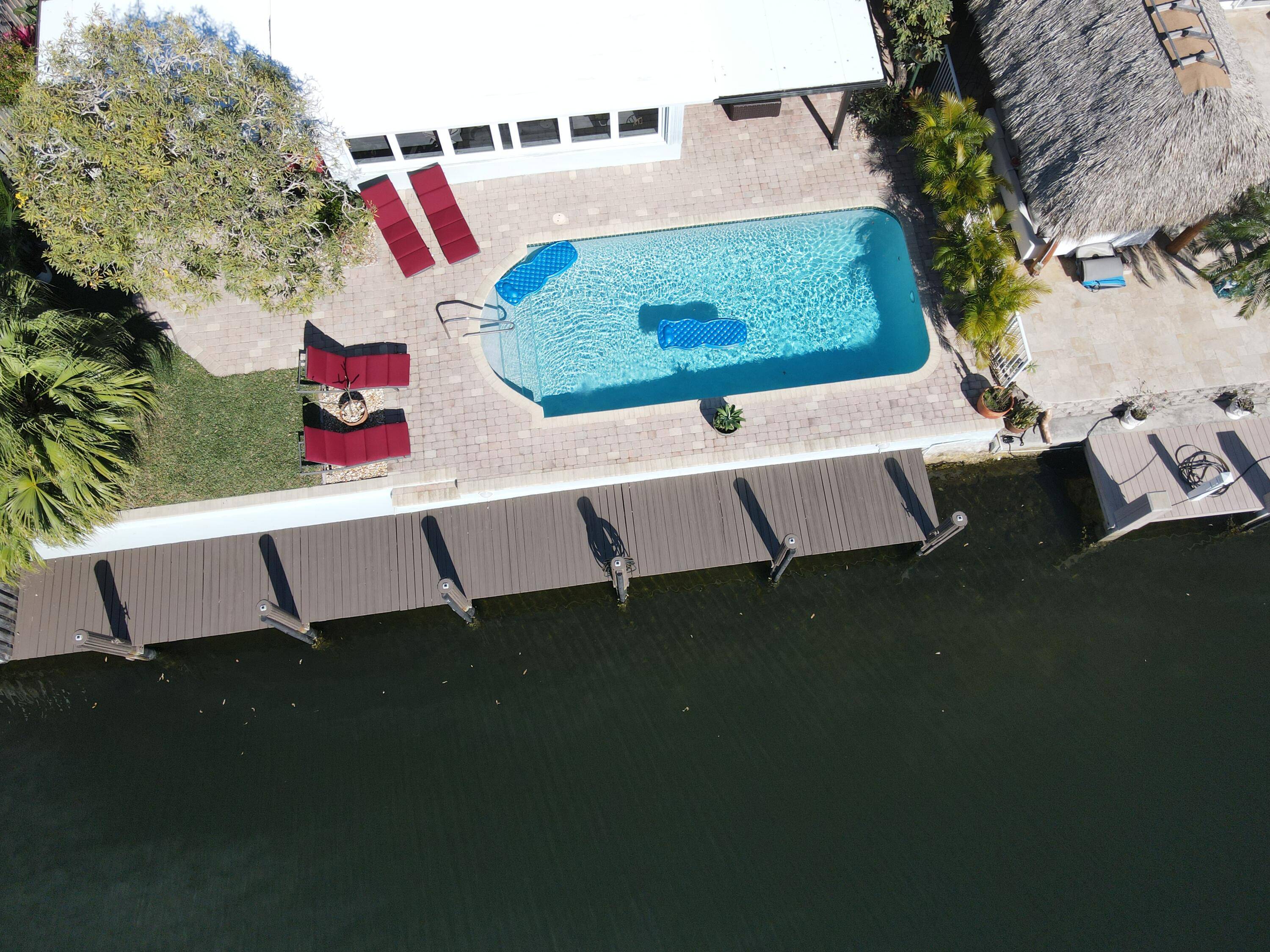 This is an exquisite, furnished home situated on a canal with no fixed bridges in Pompano Beach Isles.