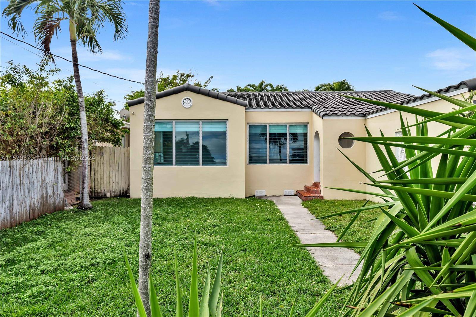 This delightful home is situated in the heart of Surfside, boasting three bedrooms plus a den and two bathrooms, all adorned with original wood floors.