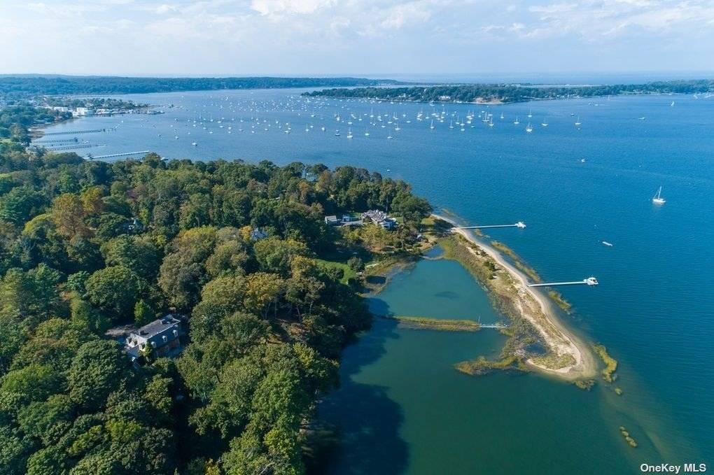 Greenbridge, a magnificent waterfront brick Georgian Manor, overlooks picturesque Oyster Bay Cove with distant views to Seawanhaka Yacht Club.
