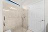 Primary Bathroom Featuring a Frameless Glass-Enclosed Shower