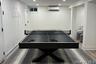 Rec room featuring an AC wall unit and recessed lighting