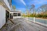 Wooden terrace featuring a sunroom and a pool