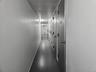 Hall with concrete floors and baseboards