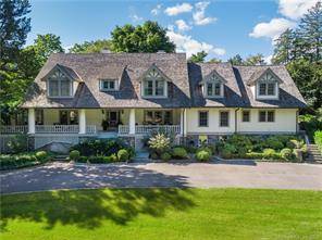 Elegant English Manor sits on 2 beautifully landscaped acres in prestigious Rock Ridge Association near town schools.
