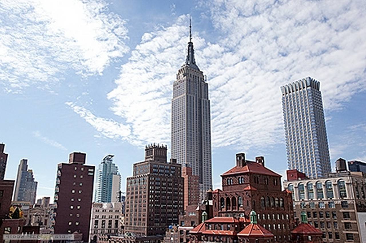 This unique high floor condo with walls of windows west and south affords endless open views of sky and the Empire State Building.