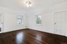 Second floor bedroom and dark wood-style floors