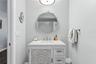 En-suite bathroom with newer vanity and shower/tub combo.