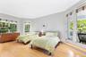 Bedroom with access to exterior, ornamental molding, and wood finished floors