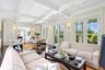 Living area featuring beamed ceiling, wood finished floors, coffered ceiling, french doors, and recessed lighting