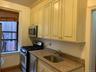 Kitchen featuring appliances with stainless steel finishes and dark stone counters