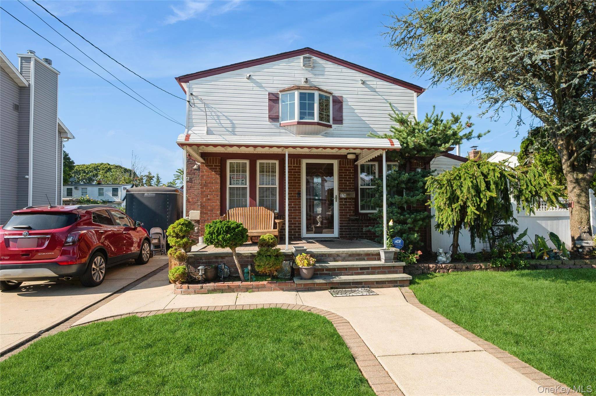 Charming 3 Bedroom, 3 Bath Brick Colonial, and an open concept kitchen with granite countertops, stainless steel appliances, and a peninsula.