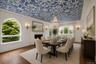 Elegant dining room with an ornamental plasterwork ceiling with another cozy fire place