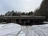 Snow covered building featuring a wooded view