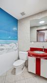 Half bath with vanity, tile walls, and light tile patterned floors