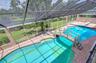 Screened swimming pool designed for recreation.