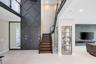 Lutron Automated Lighting throughout the entire house. Glass enclosed display room w shelving. Easy to make into a wine room.