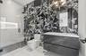 Full bath featuring tile walls, vanity, a shower stall, and tile patterned flooring