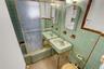 Full bathroom with tile walls and shower / bath combination with glass door