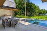 Outdoor kitchen and dining, resort style swimming pool and water views