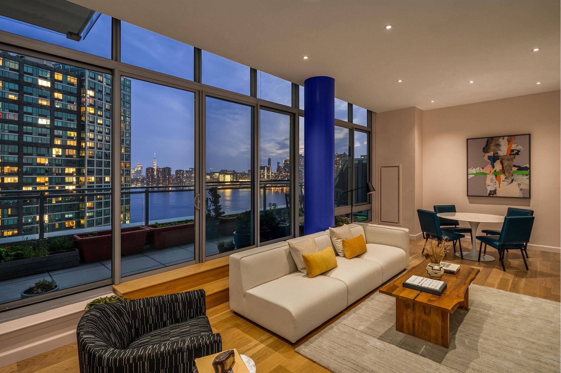 A duplex penthouse featuring floor to ceiling windows and an expansive terrace with protected East River and Manhattan skyline views ?