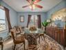 Tiled dining area with ceiling fan and baseboards