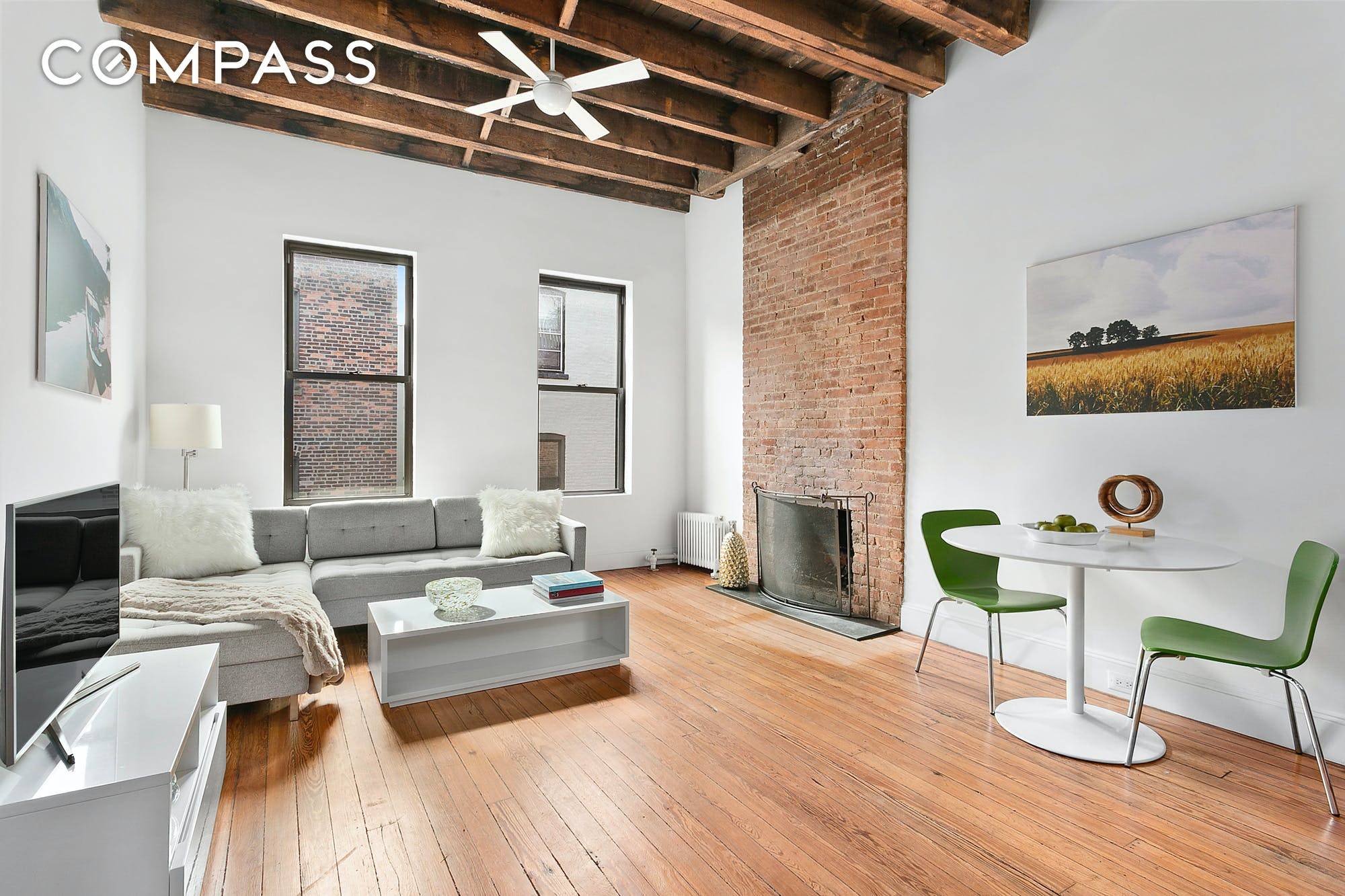 The quintessential West Village one bedroom home beamed ceiling, exposed brick, hardwood floors, and a fireplace which can be made wood burning.