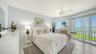 The primary suite enjoys sweeping views of the bay.