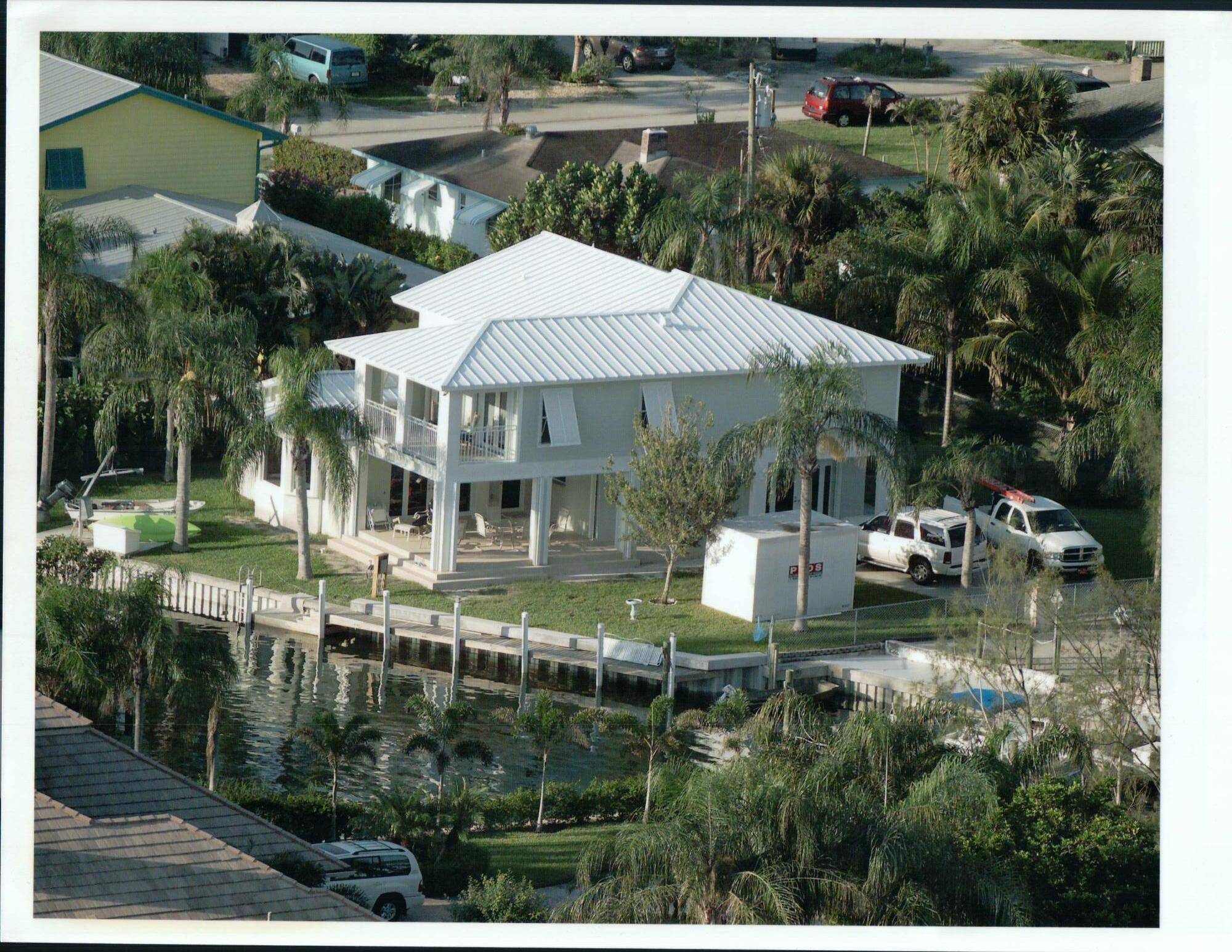 This 2 story Key West style 3 bedroom, 3 bath home situated on a tranquil protected canal just off the intracoastal.