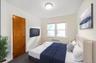 Bedroom featuring carpet and radiator