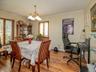 Dining space with crown molding, a chandelier, and wood finished floors