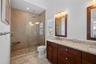 Walk in, glass enclosed shower with dual vanity in Primary En Suite