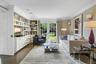 Sitting room with crown molding, dark wood-style flooring, and french doors
