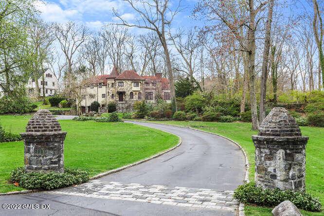 Located in the private gated community of Milbrook Association, this stately stone manor sits on 1.