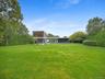 View of grassy yard with a patio