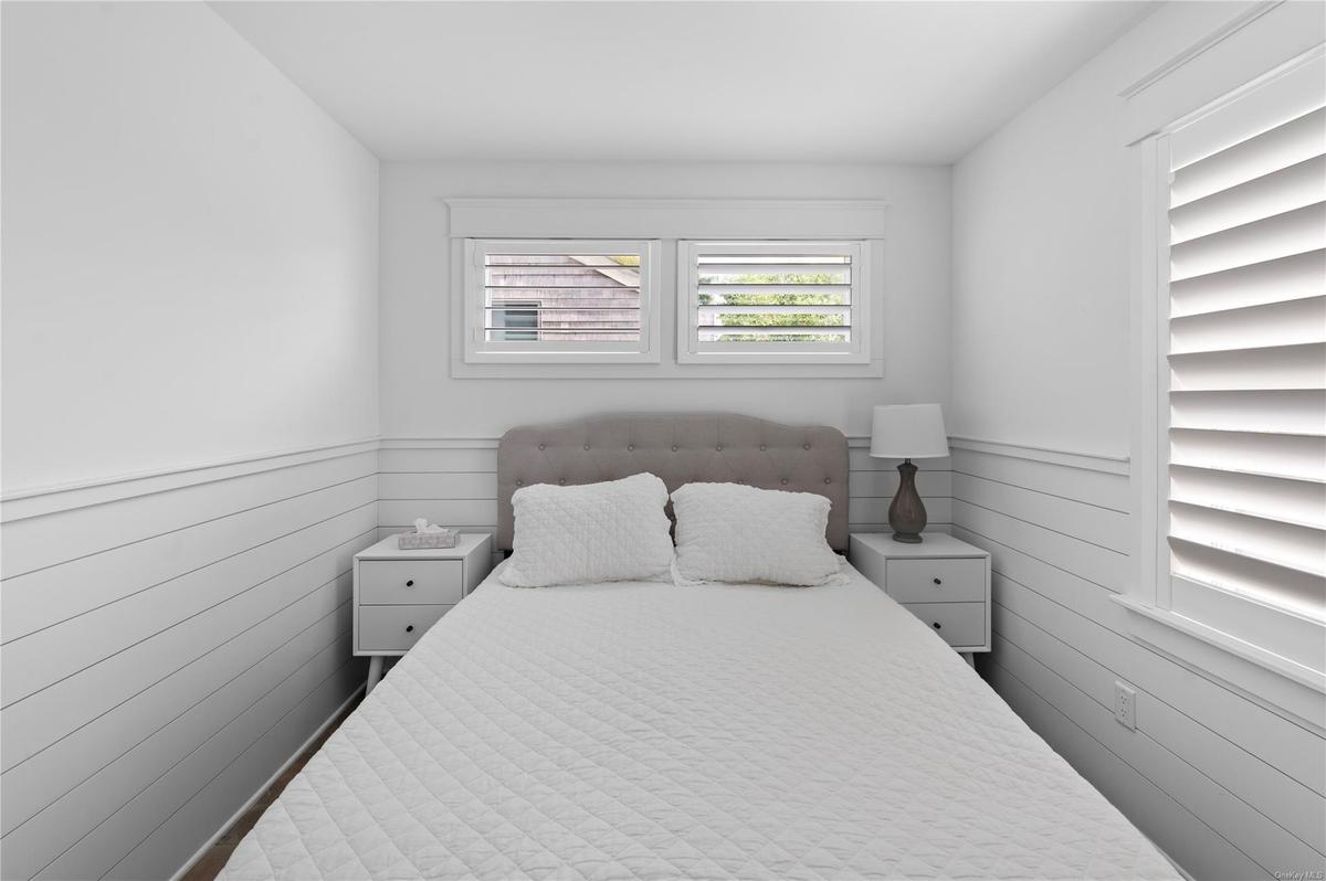 Bedroom featuring wooden walls