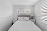 Bedroom featuring wooden walls