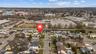 Aerial view of property's location featuring nearby suburban area showing nearby school