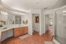 Expansive primary bathroom with generous vanity space and abundant storage