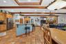Open-Concept Gourmet Kitchen, Dining & Family Room with Exposed Wood Beams