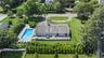 View of subject property featuring a pool area
