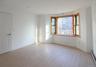 Spare room with a baseboard radiator and light wood-type flooring