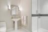 Bathroom with light tile patterned floors and a shower stall
